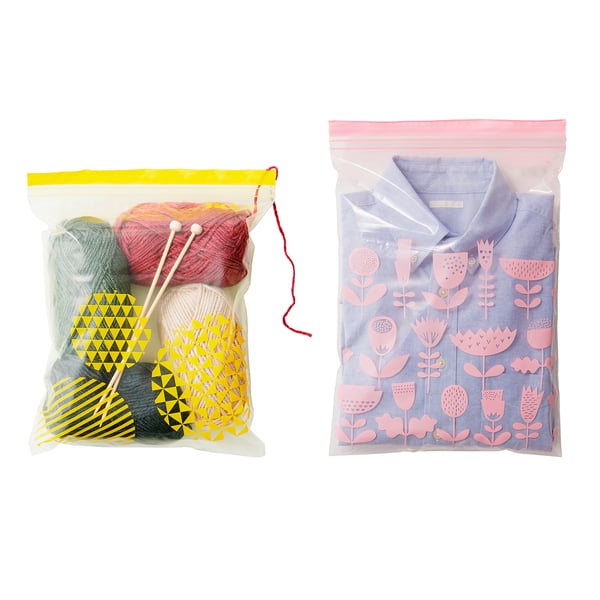 Two resealable plastic bags, one containing colourful yarn and knitting needles, the other holding a patterned fabric item.