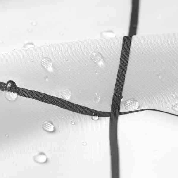 Water droplets beading on sleek, dark lines of grey shower curtain, demonstrating its water-repellent surface.
