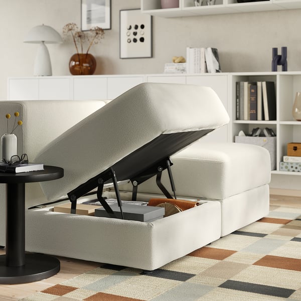 Modern living room with white JÄTTEBO sofa, storage, lamp, rug, and bookshelf.