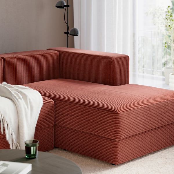 Red, modern modular sofa with chaise lounges, ideal for relaxation and socialising. Soft, textured upholstery and deep seats for comfort.