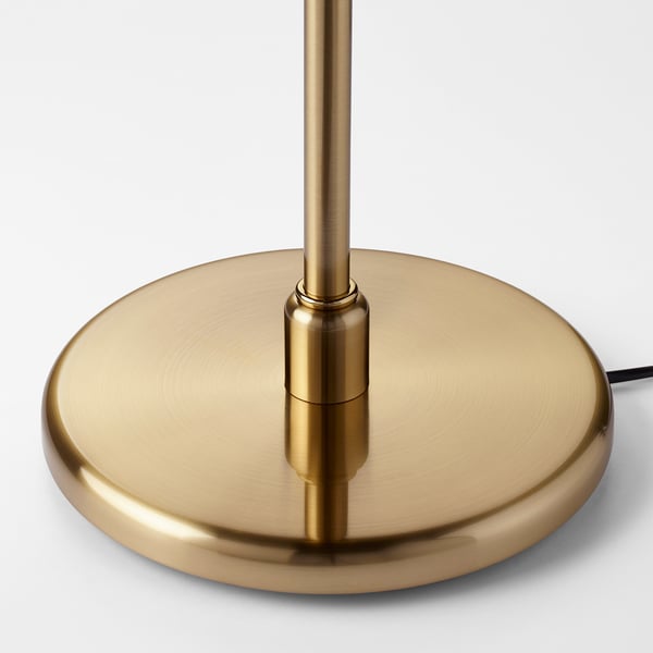 Gold lamp base with round base and vertical rod, shining metallic finish.