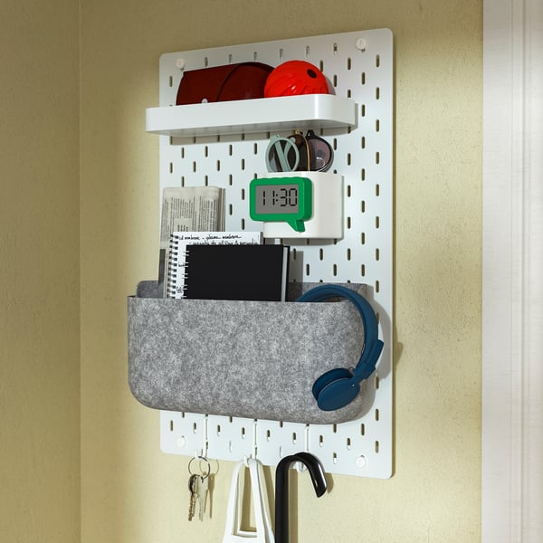 Wall-mounted organiser with clock, headphones, keys, and sunglasses.