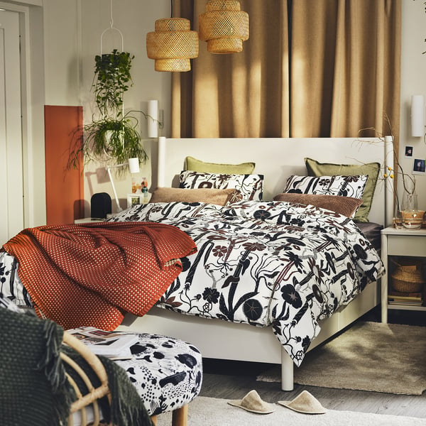 LUNDSKAFTING botanical duvet set in neutral colours on a white bed. Smooth, crisp percale cotton/lyocell blend.