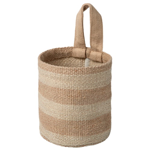 The MÄVINN storage basket is a beige, woven jute container with a cotton handle, perfect for organising small items.