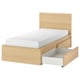 The MALM bed a light oak finish, with a white mattress and open storage drawer. Modern and minimalist design.
