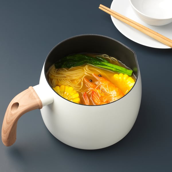 A white saucepan with a wooden handle, filled with noodles, shrimp, corn, and green vegetables. Perfect for cooking soups and sauces.