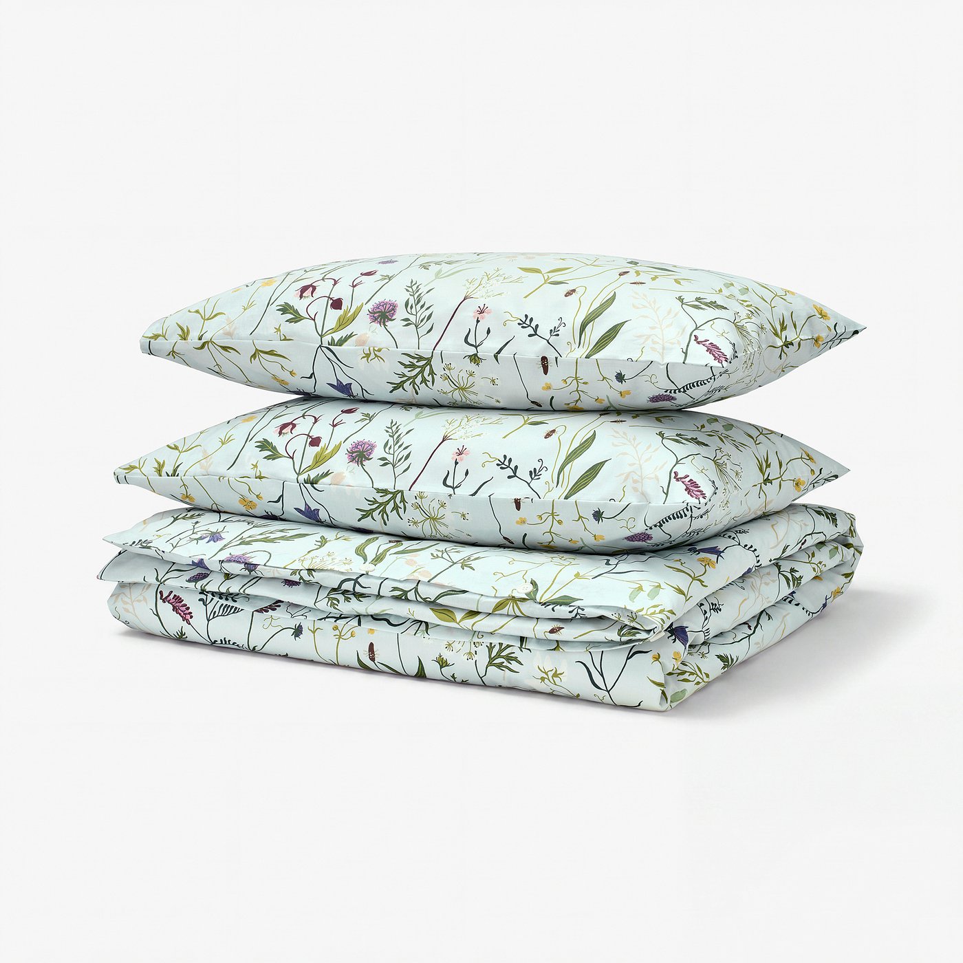 Three folded pale blue MATTOXBÄR duvet covers with floral designs, stacked neatly.