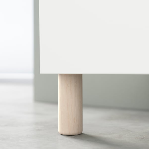 A single MEJARP leg, light wood colour, made of solid birch, supporting a white furniture piece.