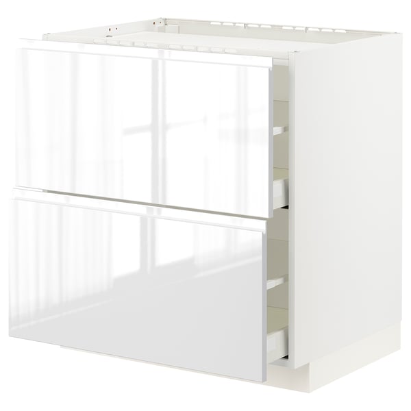 A white high gloss METOD kitchen cabinet with integrated handles and smooth-running drawers.