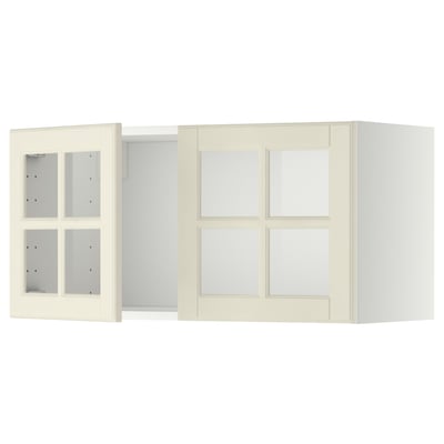 Off-white METOD kitchen cabinets with glass doors, bevelled edges, and a sturdy frame.