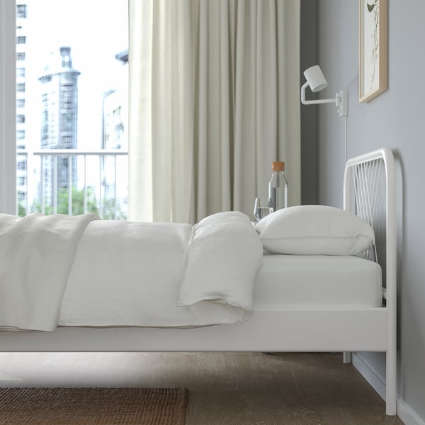 Modern minimalist bed with net headboard, city views, steel construction, storage.