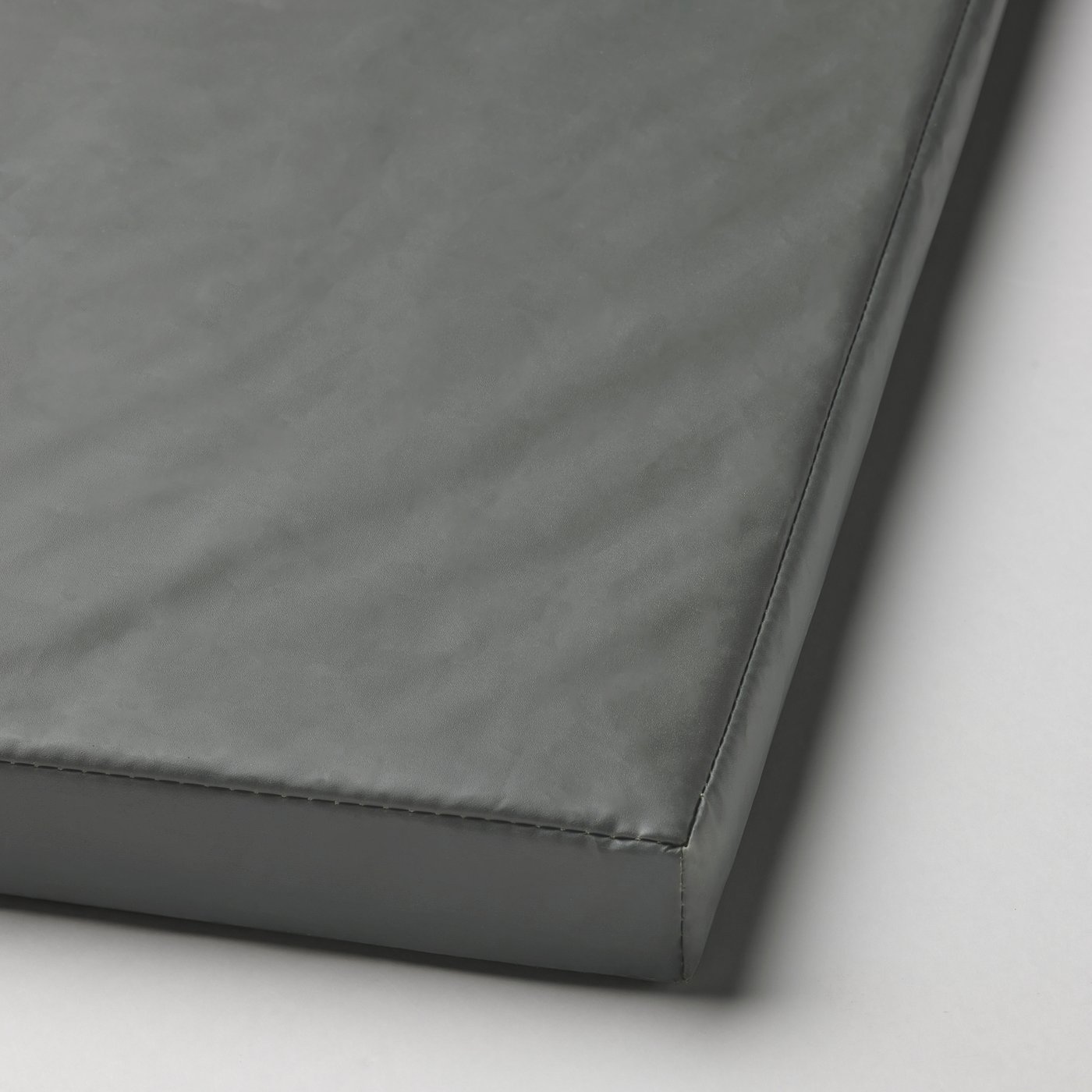 Foldable gym mat in dark grey with smooth, padded surface and secure stitching.