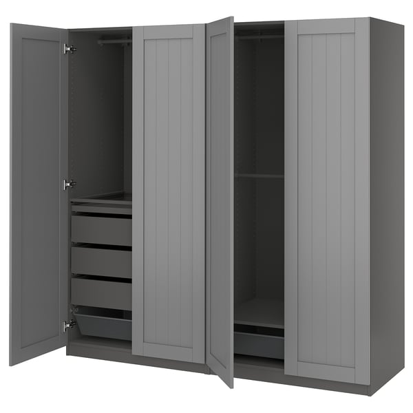 A grey PAX wardrobe with open doors, revealing drawers and shelves inside.