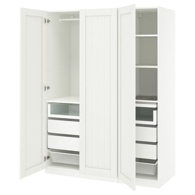 A white ikea PAX wardrobe with open doors, displaying shelves and drawers inside. Its a modern, functional design with white laminate finish.