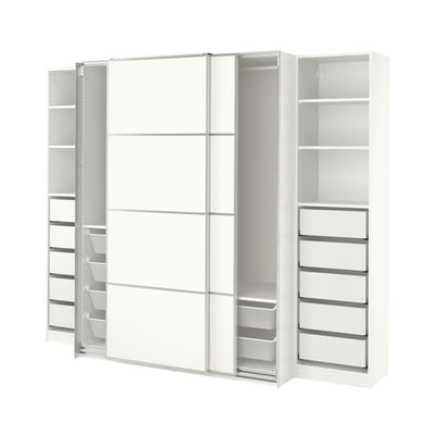 Displays a white PAX wardrobe with sliding doors, consisting of shelves and mesh drawers for organised storage.