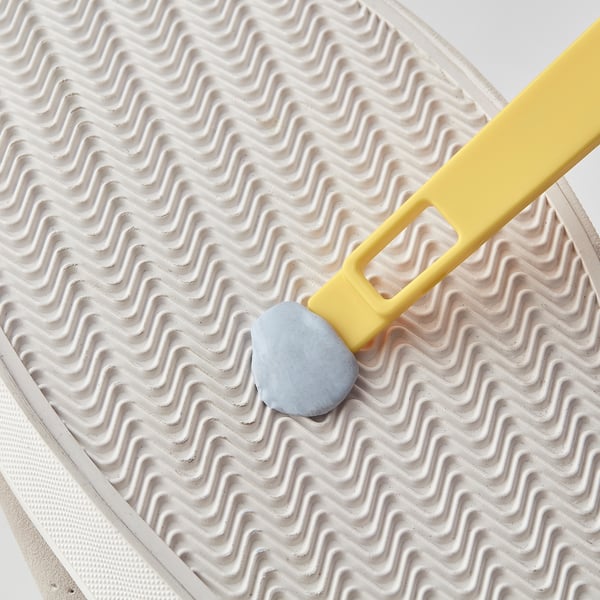 Small yellow shoe brush with a scraper end, perfect for removing surface dirt and marks.