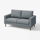 A grey, modern love seat sofa with wooden legs and a simple, clean design.