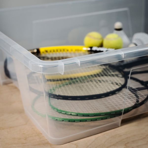 Plastic box with 2 tennis rackets and balls.