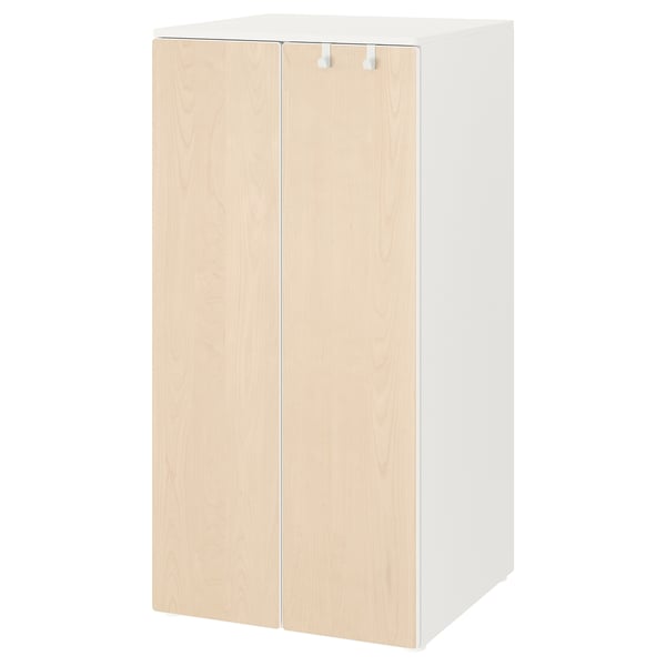 A white SMÅSTAD wardrobe with light wooden doors. Its designed for children, with soft-closing hinges and adjustable interiors.