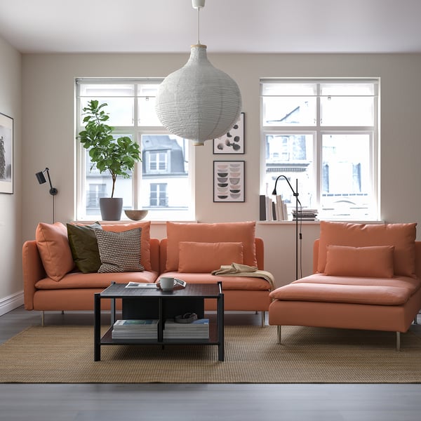 Modern living room with orange SÖDERHAMN sofa set, big windows, plant, pendant lamp, and coffee table.