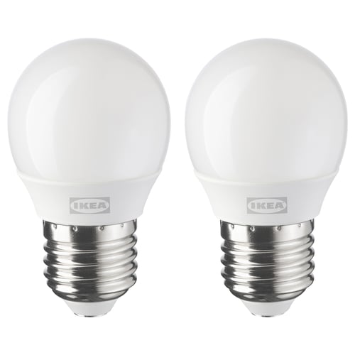 Two identical ikea led light bulbs, white, round shape with e26 base, stand side by side.