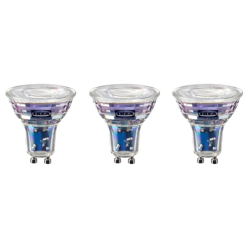 Three ikea SOLHETTA light bulbs in a row, clear with decorative tops, on white background.