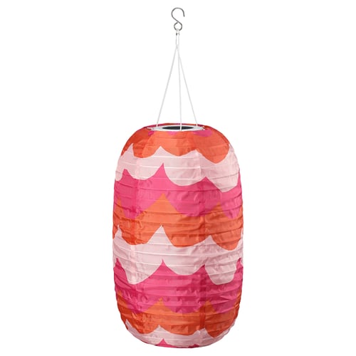 The SOLVINDEN lamp bright pink and orange scalloped designs, crafted from recycled materials, and hangs from a hook.