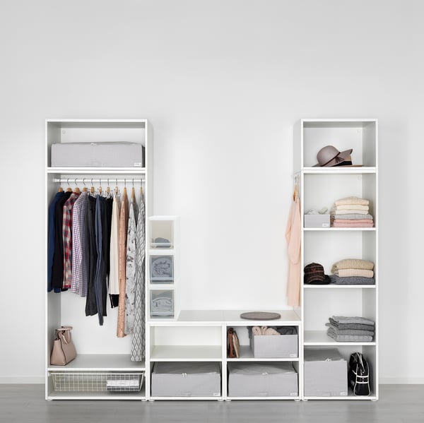 Well-organized closet with clothes, accessories, and storage bins, featuring pull-out shelves for easy access.