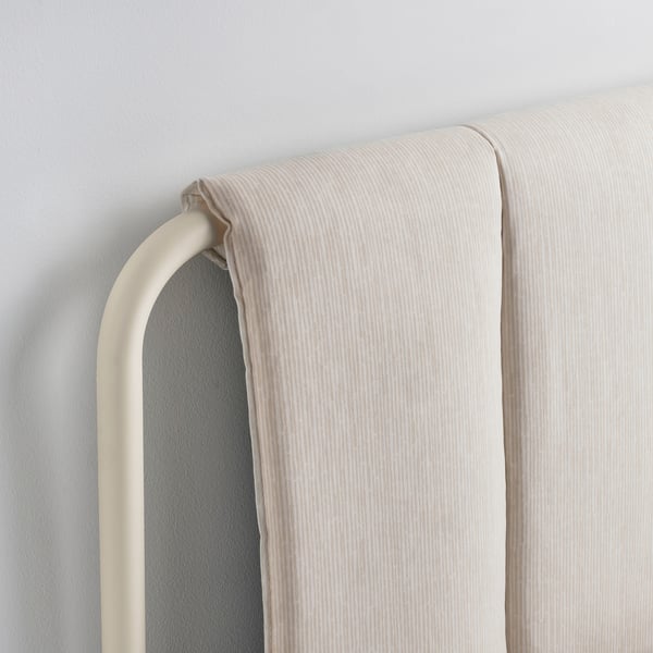 Modern bed frame with plush, striped headboard, sleek metal legs, and clean lines.