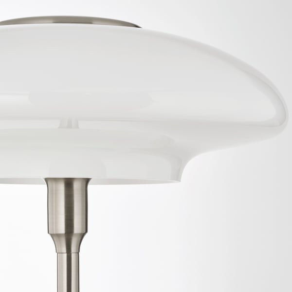 Modern lamp with large, white, opaque glass shade and sleek, nickel-finished metal base. Elegant and stylish design.