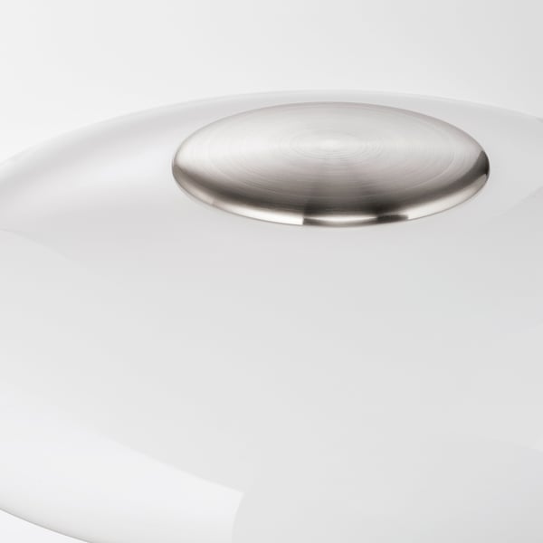 Round, polished chrome lamp shade sits atop a smooth white base, reflecting light and elegance.