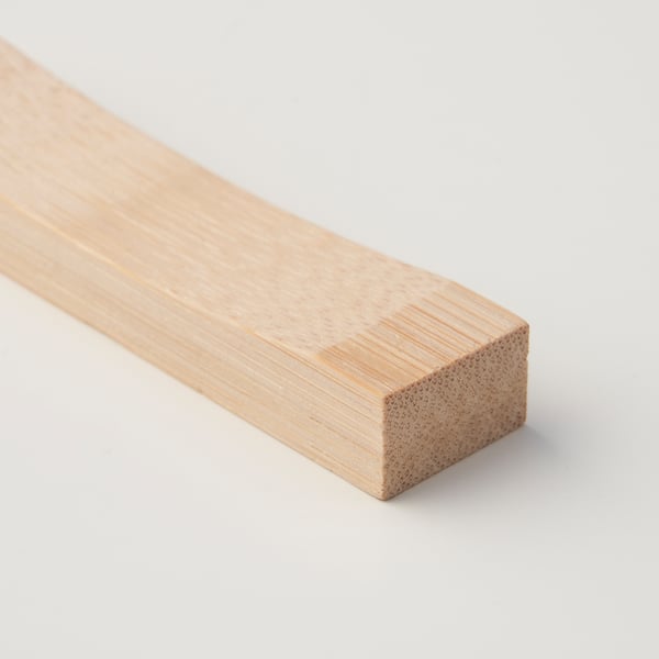 Sleek wooden chopstick rest, natural bamboo finish, clean design.