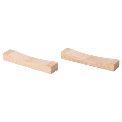 Two light brown, rectangular bamboo chopstick holders with curved grooves, side by side.