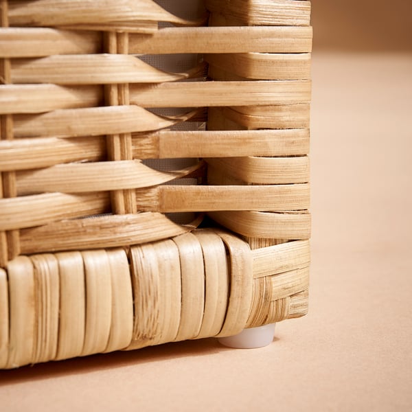 Woven basket detail, crafted with natural rattan. Decorative, woven texture with tight, even weave. Skilled craftsmanship evident in design.