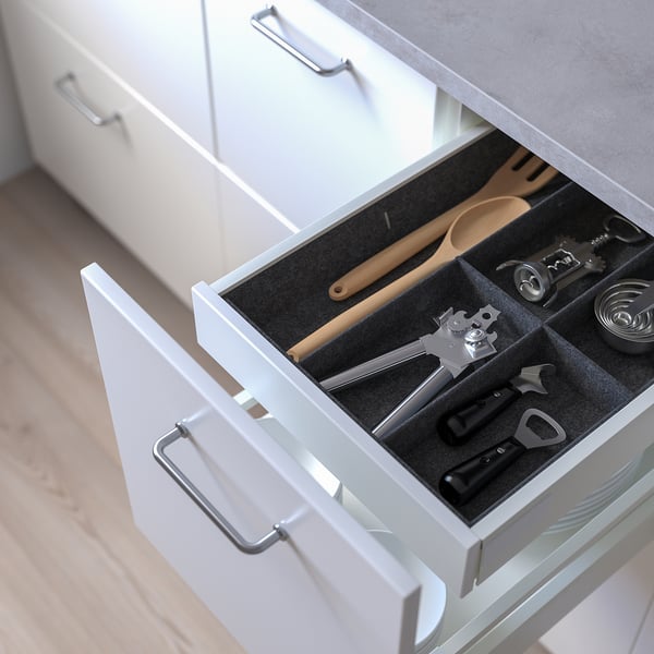 Open kitchen drawer showing organised utensils, with adjustable dividers for custom fit.