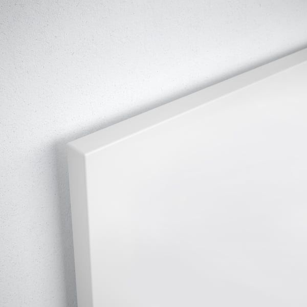 Clean-lined white bed frame corner; smooth finish, minimalist design.