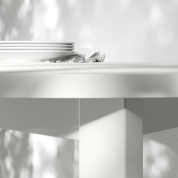 Close-up of clean, modern table edge and shiny silverware.