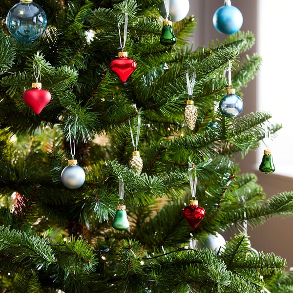 Christmas tree decorated with colourful VINTERFINT glass ornaments: red, blue, green, and gold, featuring hearts, bells, cones, and baubles.