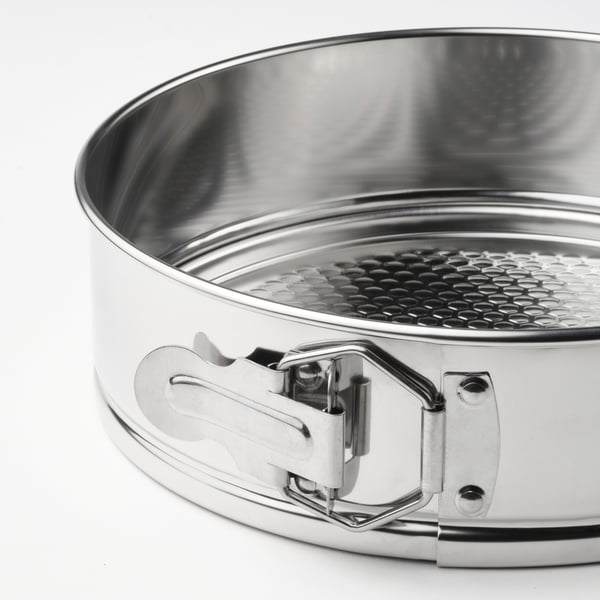 Close-up of a stainless-steel springform pan showcasing its smooth, even-heating surface and secure latch.