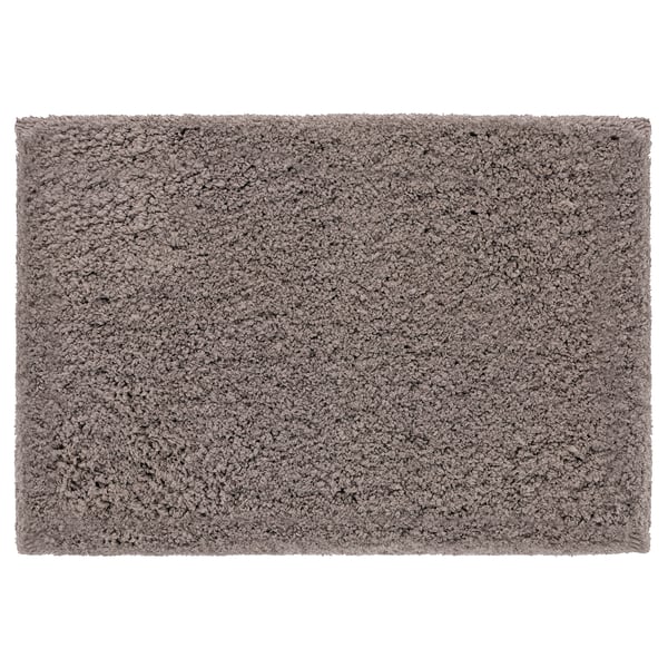 Beige ALMTJÄRN bath mat, soft polyester microfiber, rectangular shape, plain design.