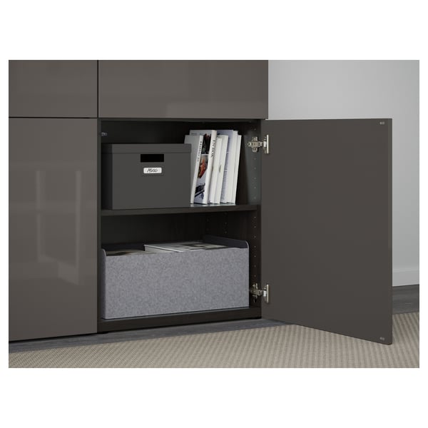 Open storage unit with boxes and papers. Two shelves, one soft-close door open.