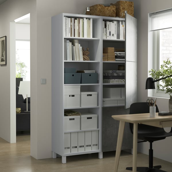 Modern BESTÅ storage with adjustable shelves, holding books, boxes, and decor.