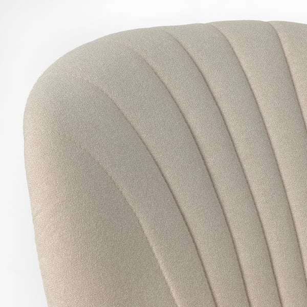 Back of modern, upholstered chair with pleated, beige fabric. Shows clean design and comfort focus.