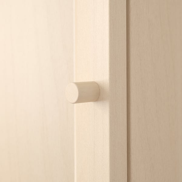 A sleek, modern door handle crafted from a smooth, light-colored material, securely attached to a plain wooden door.