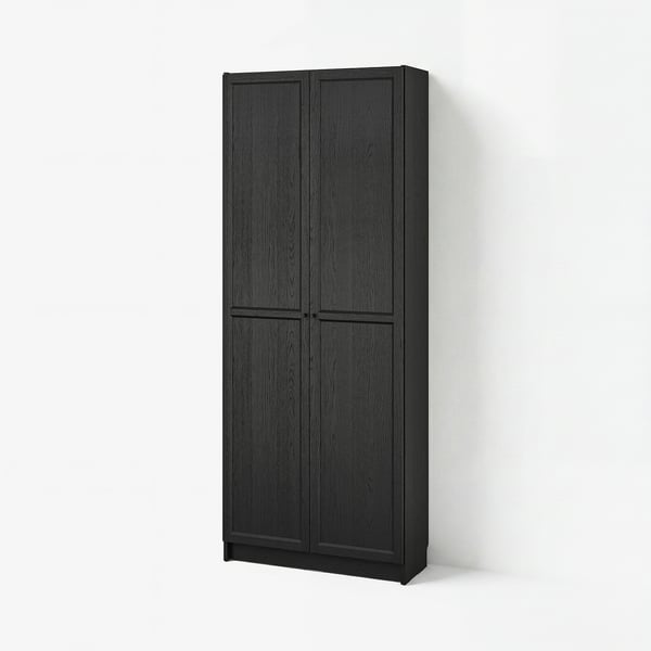Black BILLY bookcase with vertical panels and two doors against white wall.