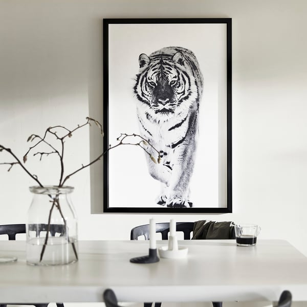Large wall art: black-white tiger canvas; slim black frame; minimalist decor.