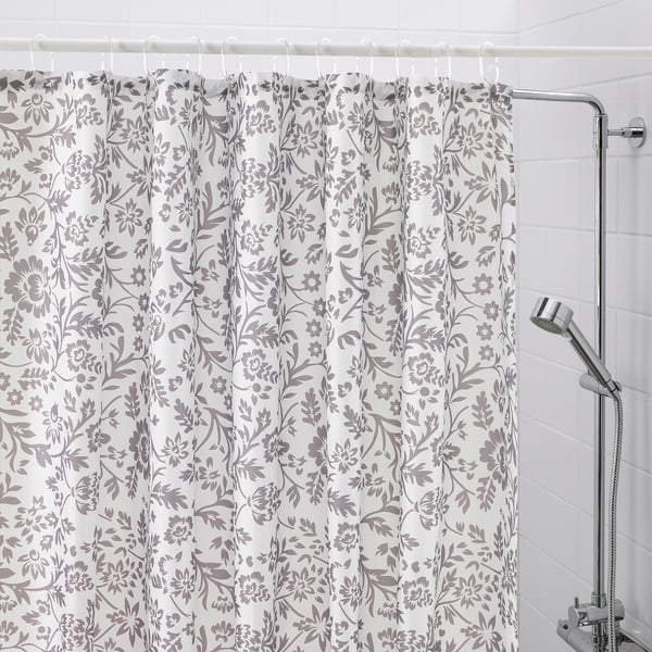 Floral shower curtain, chrome rod, handheld shower head alternatively: floral curtain, chrome rod, handheld shower