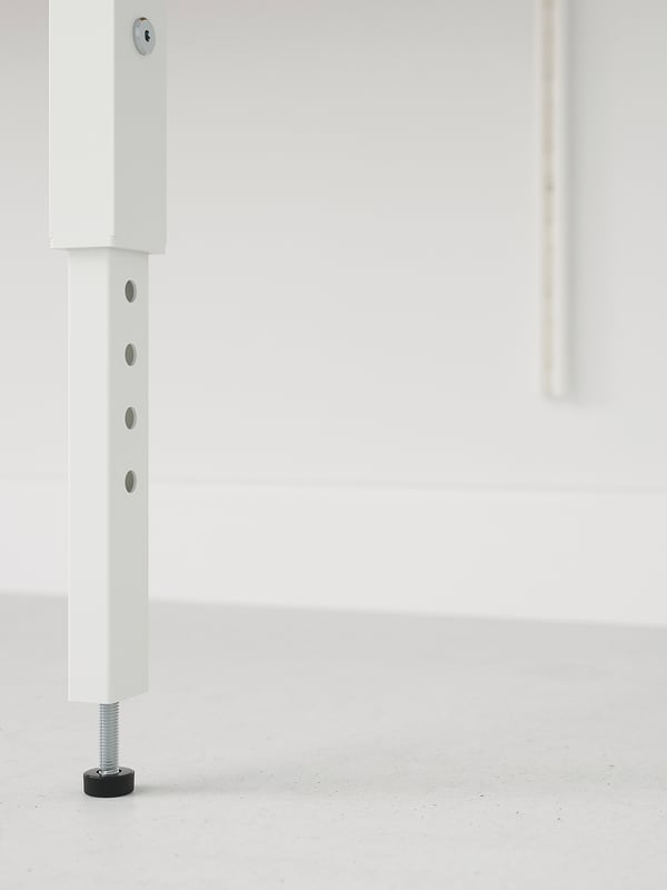 White metal legs with adjustable feet. One has screws and knobs for stability.