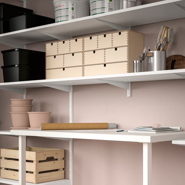 Shelf with books, pots, and tools for home organisation.
