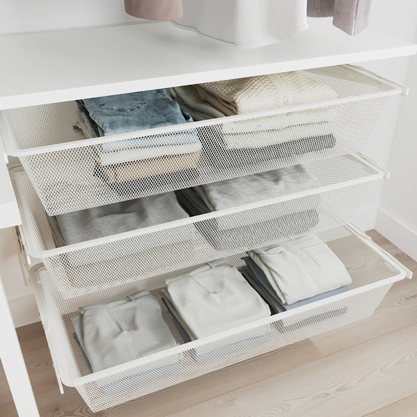 Open wardrobe with mesh drawers storing folded clothes, part of BOAXEL storage system.